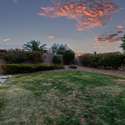 This private yard blends a soft green lawn with low-maintenance desert landscape, offering a peaceful balance of usable space and natural beauty. Enjoy tranquil moments in a yard designed for both serenity and play.