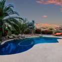 Framed by flowering shrubs and desert palms, this poolscape captures the essence of twilight luxury. Relax in style with soothing water features, natural stone accents, and an entertainer s layout that s picture perfect.