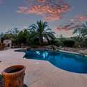 From the curved pool edges to the surrounding natural rock elements, this backyard radiates a serene, upscale resort feel. Twilight ambiance and lush privacy plantings complete the scene, ideal for Scottsdale s year-round lifestyle.