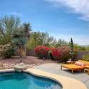 This tranquil lounge area is ideal for sunbathing or sipping cocktails poolside. Surrounded by desert greenery, the curved pool deck offers privacy and beauty, making it the perfect place to enjoy outdoor living in the heart of Scottsdale.