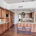 Designed for the culinary enthusiast, this spacious kitchen features premium wood cabinetry, granite counters, and a grand island with bar seating. A cabinet painting allowance invites you to add your personal touch to this elegant space.