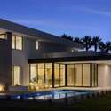 This evening view highlights the home s sleek pool and covered patio, enhanced by ambient lighting and minimalist landscaping perfect for refined outdoor living in Phoenix s coveted Arcadia area.