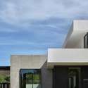 A vertical angle captures the strong architectural lines and bold material palette white stucco, dark accents, and exposed concrete define this custom Arcadia home s modern identity.