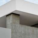 This detailed architectural shot captures the geometric precision of the roofline highlighting the crisp design and expertly executed concrete and stucco finish.
