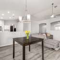 This central dining area anchors the kitchen and living room with style and simplicity. Featuring modern lighting, luxury vinyl flooring, and flexible design, it's ideal for entertaining or everyday meals.