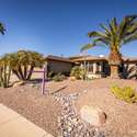 This eye-catching front yard features mature palm trees, sculpted desert plants, and decorative rock offering timeless curb appeal in the heart of Surprise, AZ. Perfect for renters looking for low-maintenance beauty.