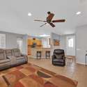 The spacious living room is designed for relaxation with reclining furniture, tile floors, and natural light. Its open-concept flow is ideal for short-term tenants wanting both space and connection.