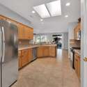 Natural light pours in through dual skylights, illuminating ample counter space and a seamless layout perfect for preparing meals or entertaining guests during your Arizona getaway.