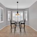 Enjoy your morning coffee or a casual lunch in this inviting breakfast nook framed by plantation shutters and scenic desert views just steps from the kitchen.