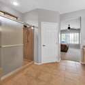 Enjoy a spacious step-in shower, modern fixtures, and ample room to get ready in this tastefully designed bathroom, attached to the primary suite for added privacy.