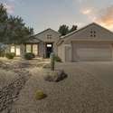 Featuring mature desert flora and drought-friendly rock accents, the front yard delivers exceptional curb appeal with low-maintenance benefits. The stucco exterior and paver-lined walkway create a welcoming entry to this stunning Surprise, AZ home.
