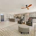 The open-concept living area flows effortlessly into the entryway and kitchen, combining functionality with a warm, modern aesthetic. With flexible space for both casual lounging and formal hosting, this great room adapts to every lifestyle.