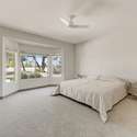 Wake up to peaceful golf course views in this spacious and serene primary suite. Plush carpet, a soft color palette, and oversized windows create a quiet, light-filled retreat at the heart of the home.