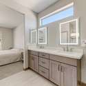 Enjoy sleek quartz surfaces, LED-lit mirrors, and sophisticated fixtures in this beautifully updated primary bathroom. Its clean lines and light-filled design elevate your daily routine with ease.