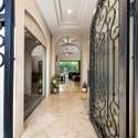 Enter through ornate wrought iron doors into a soaring foyer with polished tile floors and archways leading into the heart of the home. The Scottsdale layout flows seamlessly from front to back.