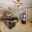 A spacious great room with a stunning fireplace centerpiece, arching transitions, and views into the chef s kitchen. Designed for relaxing, hosting, and enjoying the best of Scottsdale indoor living.