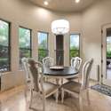 Surrounded by windows, this cozy breakfast nook offers abundant natural light and serene views of the lush Scottsdale backyard. With direct patio access, it s the perfect spot for morning coffee or casual meals.