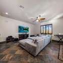 A perfect retreat for movie nights or entertaining, this large flex room features a wet bar, slate floors, and built-in cabinetry. This Scottsdale bonus space offers comfort and versatility for families and guests alike.
