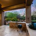 This covered patio is equipped with a built-in BBQ island, dual grills, and prep space ideal for hosting gatherings in the heart of Scottsdale s outdoor lifestyle.