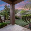 Framed by vibrant desert plants and low-maintenance turf, this backyard sitting area opens to tranquil mountain views an inviting spot for relaxation in Scottsdale s natural beauty.