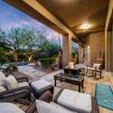Comfortable outdoor living meets desert charm on this covered Scottsdale patio. Enjoy the glow of the fire feature and pool views while shaded from the sun and surrounded by mature foliage.