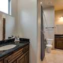A spacious Jack and Jill bathroom with dual sinks, rich cabinetry, and granite counters. This Scottsdale layout is both functional and stylish perfect for shared use among family or guests.