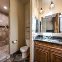 This stylish bathroom includes updated tilework, modern lighting, and a spacious walk-in shower ideal for guests or private living quarters within the casita.