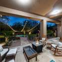 Enjoy Scottsdale evenings on this spacious patio with ambient lighting, built-in fire pit, and ample seating perfect for year-round entertaining and relaxation.