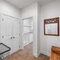 The mud room is located just off the kitchen and provides access to the laundry room and garage.