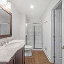 The lower-level full-bath is outfitted with a shower and a granite-topped vanity.