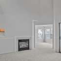 Living room with pass-through to the kitchen and gas fireplace.