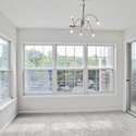 Sunroom with a view of the sliding glass door to the screened-in porch.