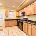 The kitchen has granite countertops, a built-in microwave, and a gas range.