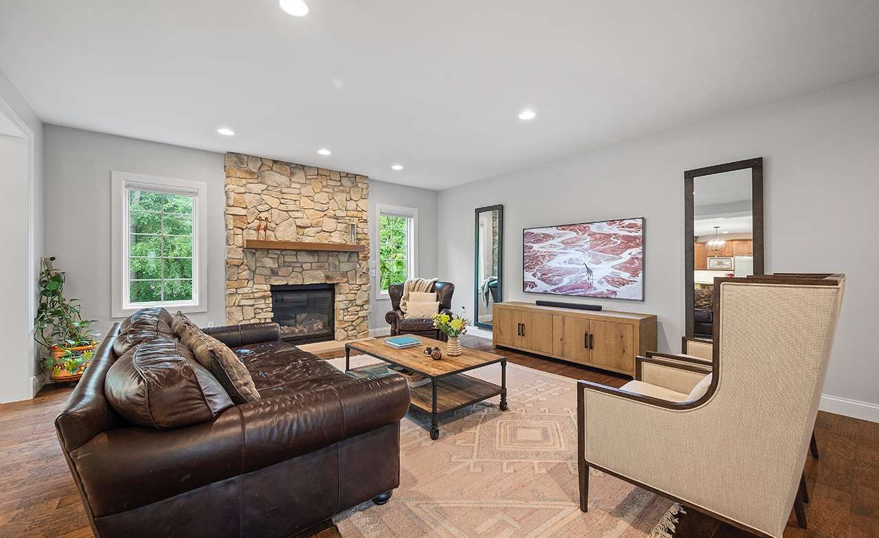 13 of 69. The focal point of the family room is a rustic fireplace.