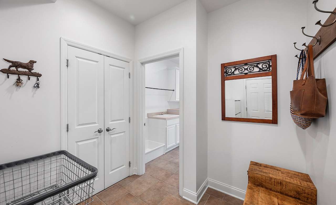 26 of 69. The mud room is located just off the kitchen and provides access to the laundry room and garage.