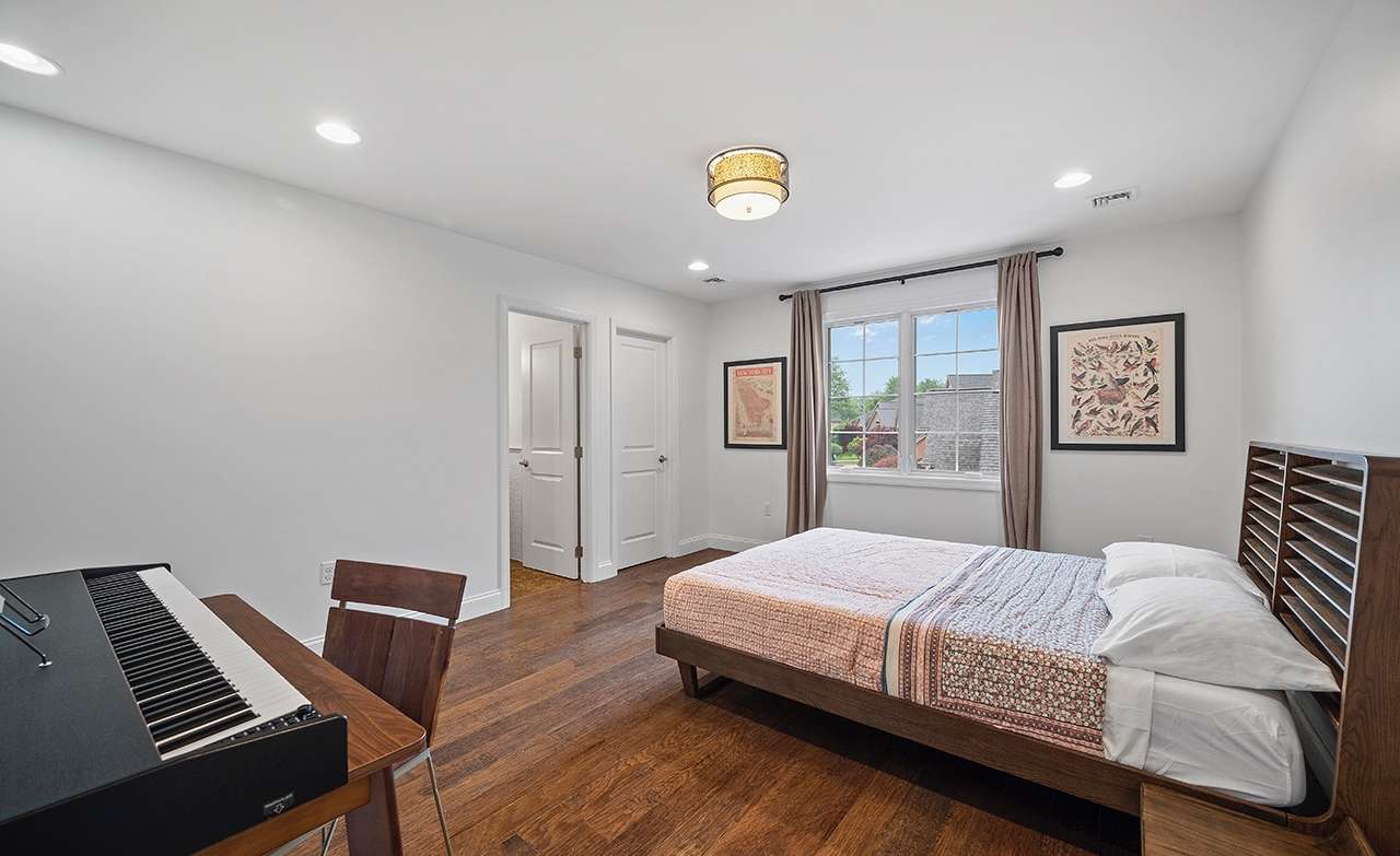 39 of 69. The large second bedroom features a walk-in closet and shares a Jack n' Jill bath with the third bedroom.