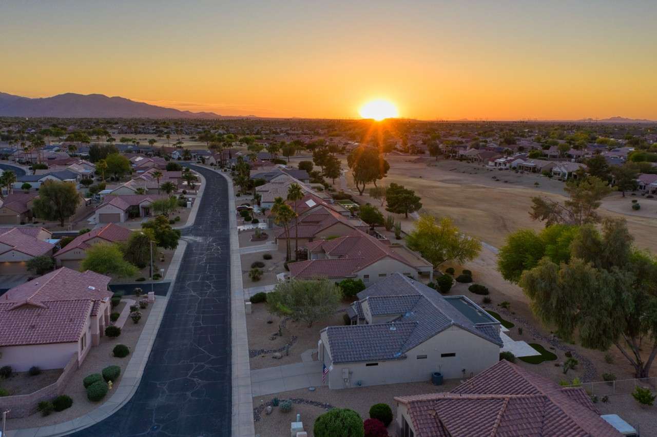 34 of 35. Gaze down this peaceful Surprise street at golden hour with panoramic sunset views stretching across the community. A picture-perfect setting to call home.