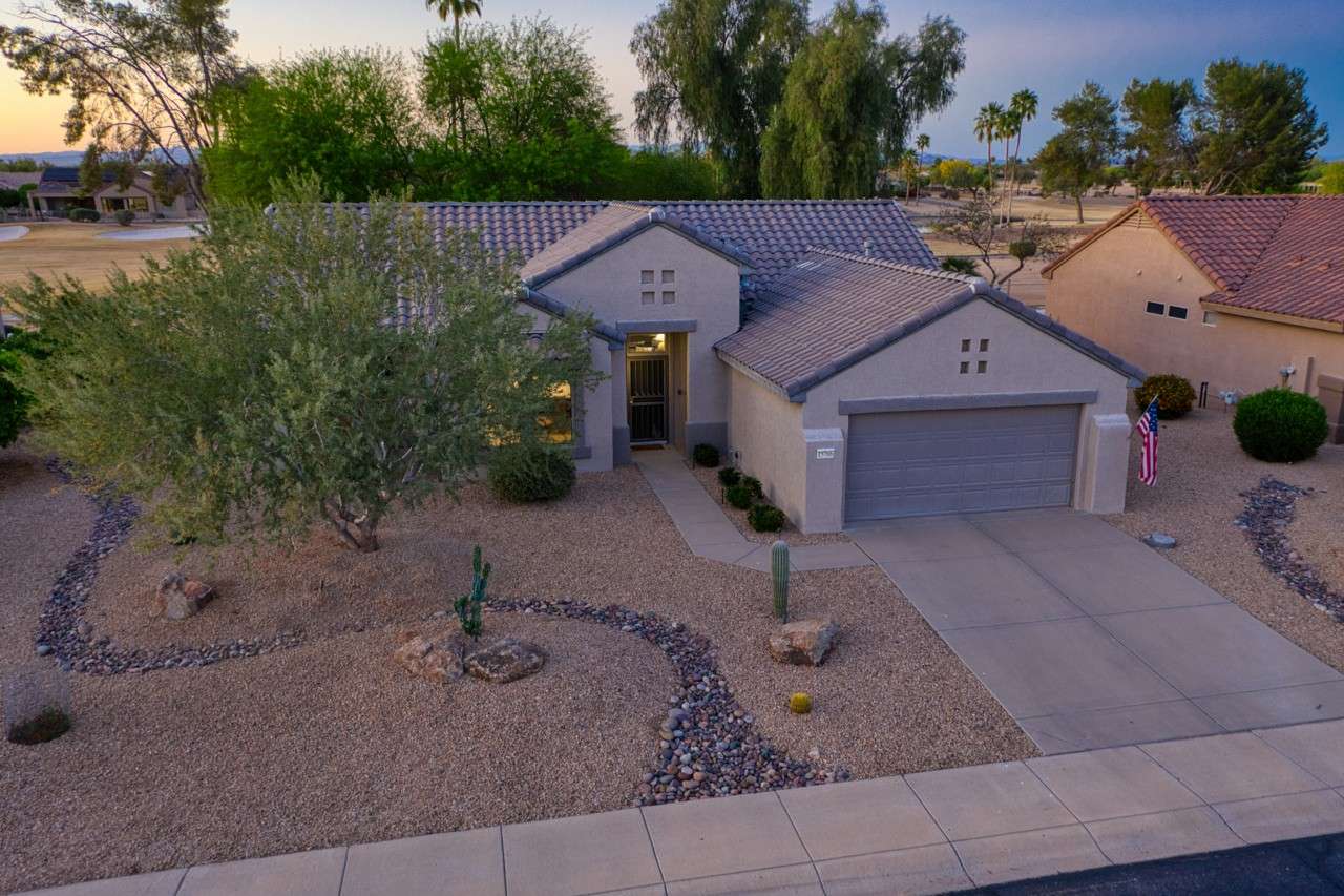 35 of 35. As the sun sets, this Surprise residence glows with warm desert tones and elegant exterior lighting. Its inviting presence is framed by native landscaping and tranquil surroundings.