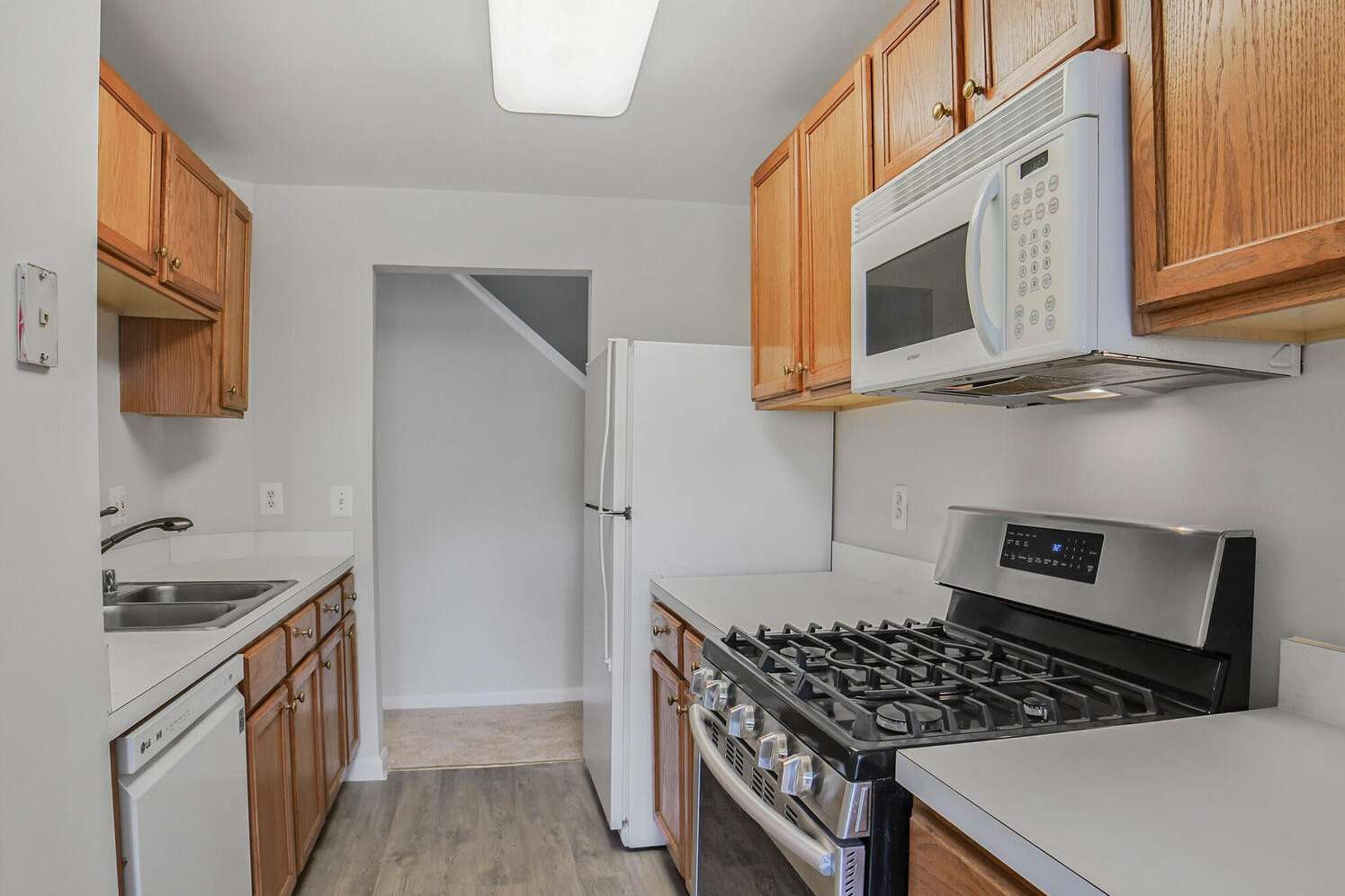 5 of 34. Kitchen with a view of the foyer hall and stairs leading to the loft space.