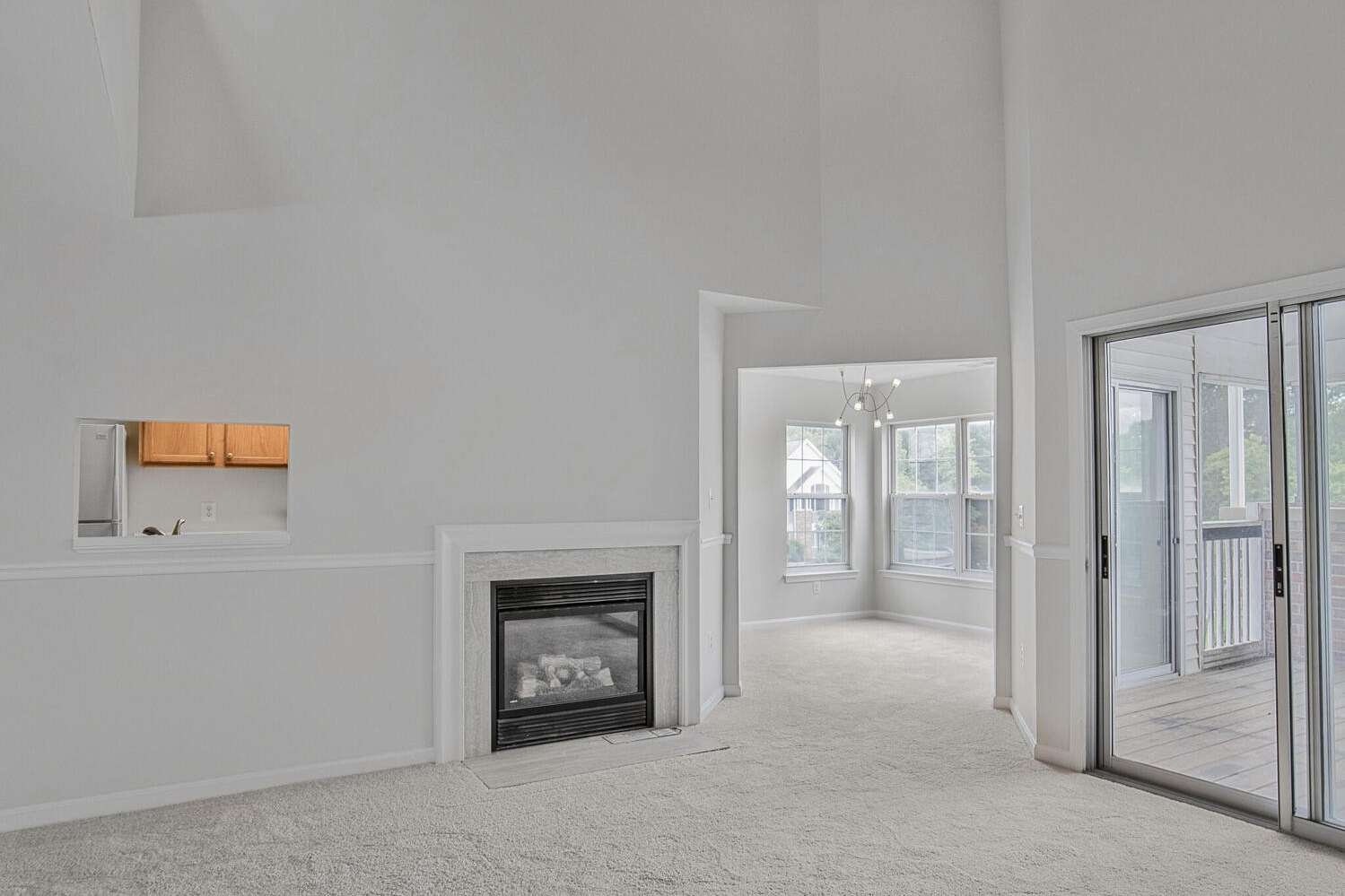 15 of 34. Living room with pass-through to the kitchen and gas fireplace.