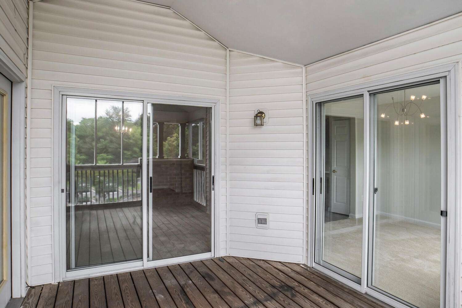 11 of 34. Screened-in Porch view into the Sunroom to the right, and the Living room straight ahead, to the left, a third door leads into the second bedroom.
