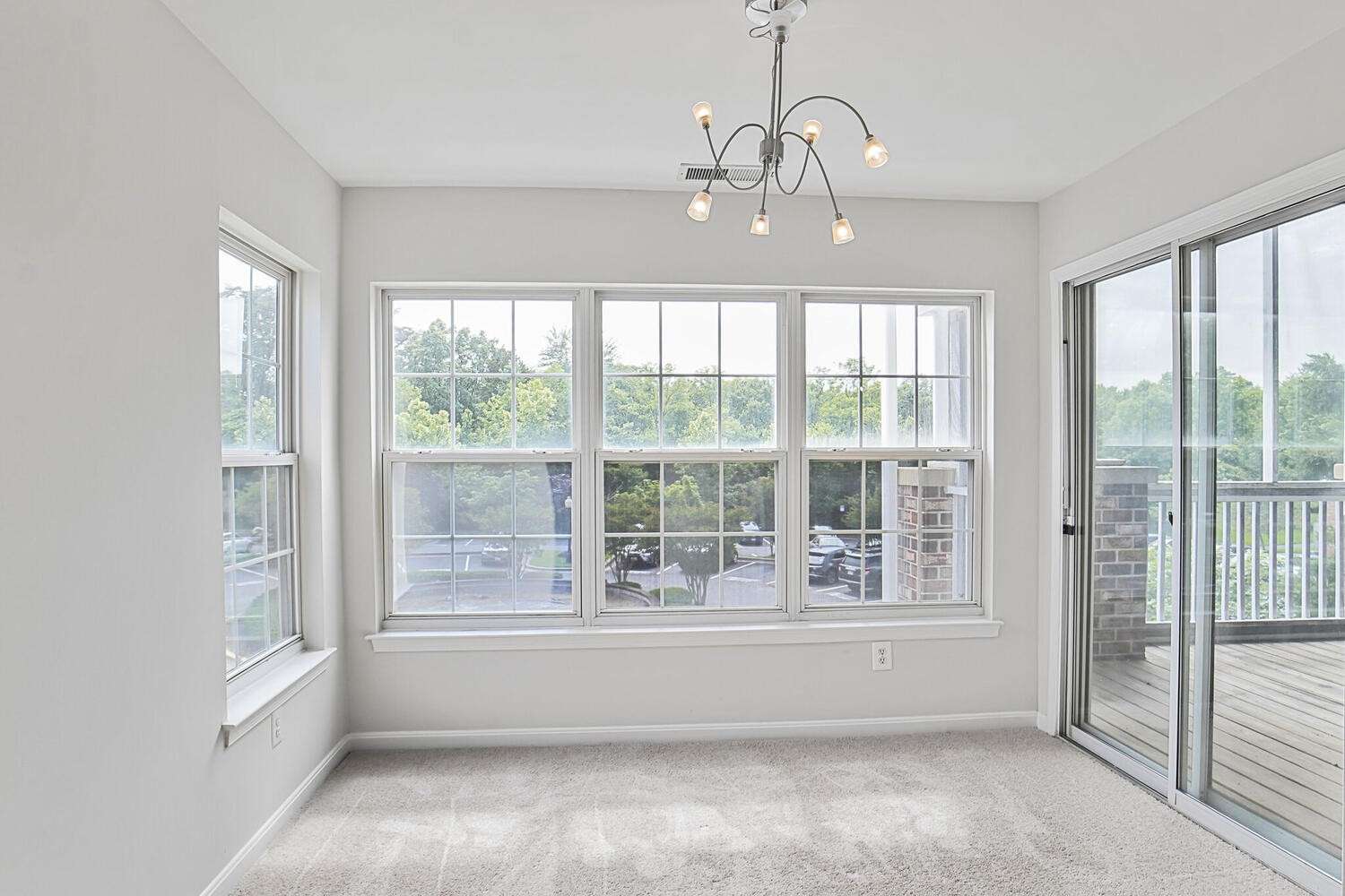 8 of 34. Sunroom with a view of the sliding glass door to the screened-in porch.