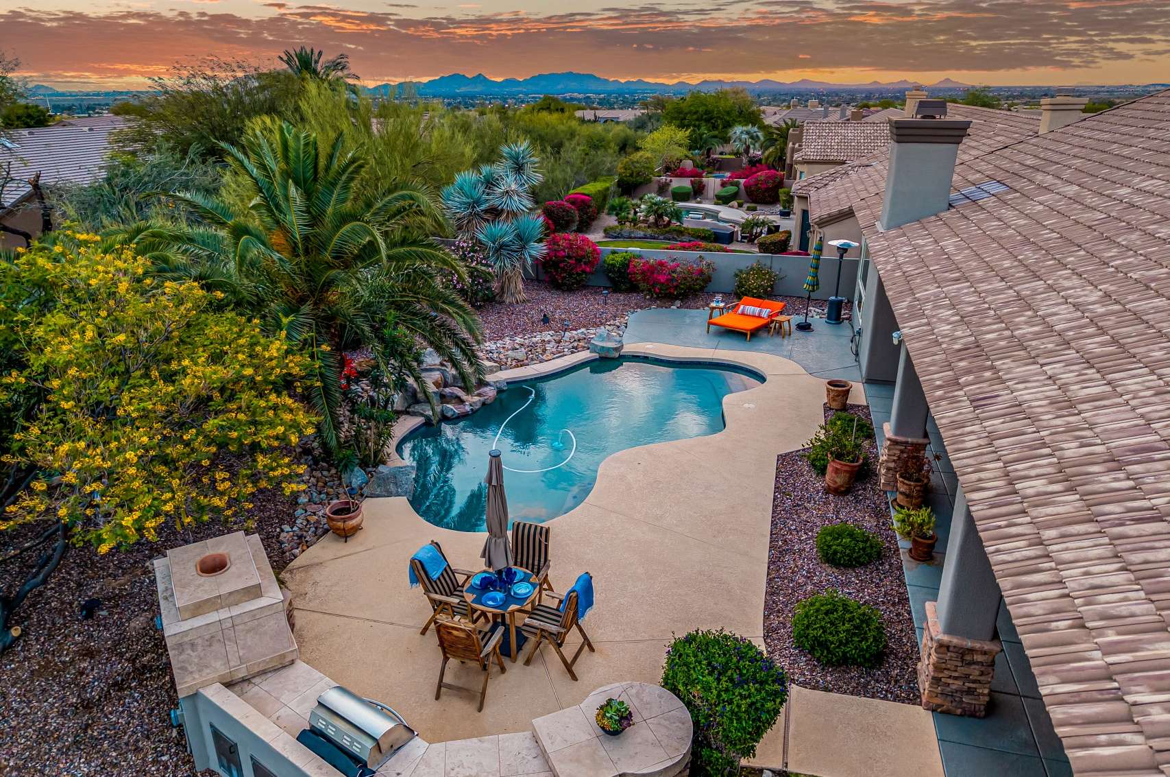 2 of 65. The elevated backyard setting captures sweeping mountain vistas and nightly sunsets. Surrounded by desert flora and built for entertaining, this backyard offers the ultimate Scottsdale lifestyle with poolside dining and expansive views.