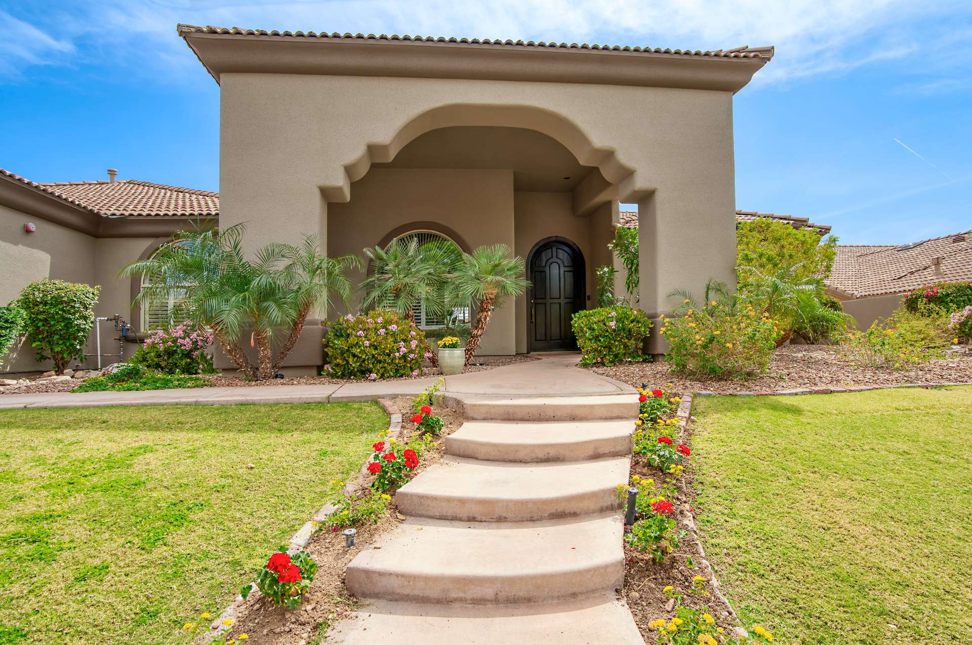 1 of 65. From its well-manicured lawn to its sculpted flower beds, this Scottsdale gem greets you with vibrant curb appeal and desert charm. The wide entry path and elevated porch create a warm, welcoming first impression in this gated community.