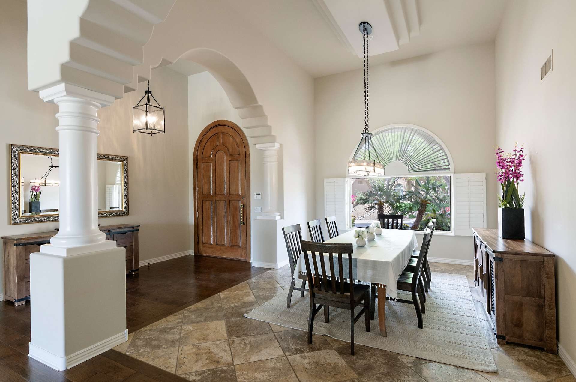 7 of 65. A graceful formal dining room opens from the arched foyer, accented by dramatic pillars, natural light, and classic finishes. Perfect for hosting or holiday gatherings in this sophisticated Scottsdale residence.