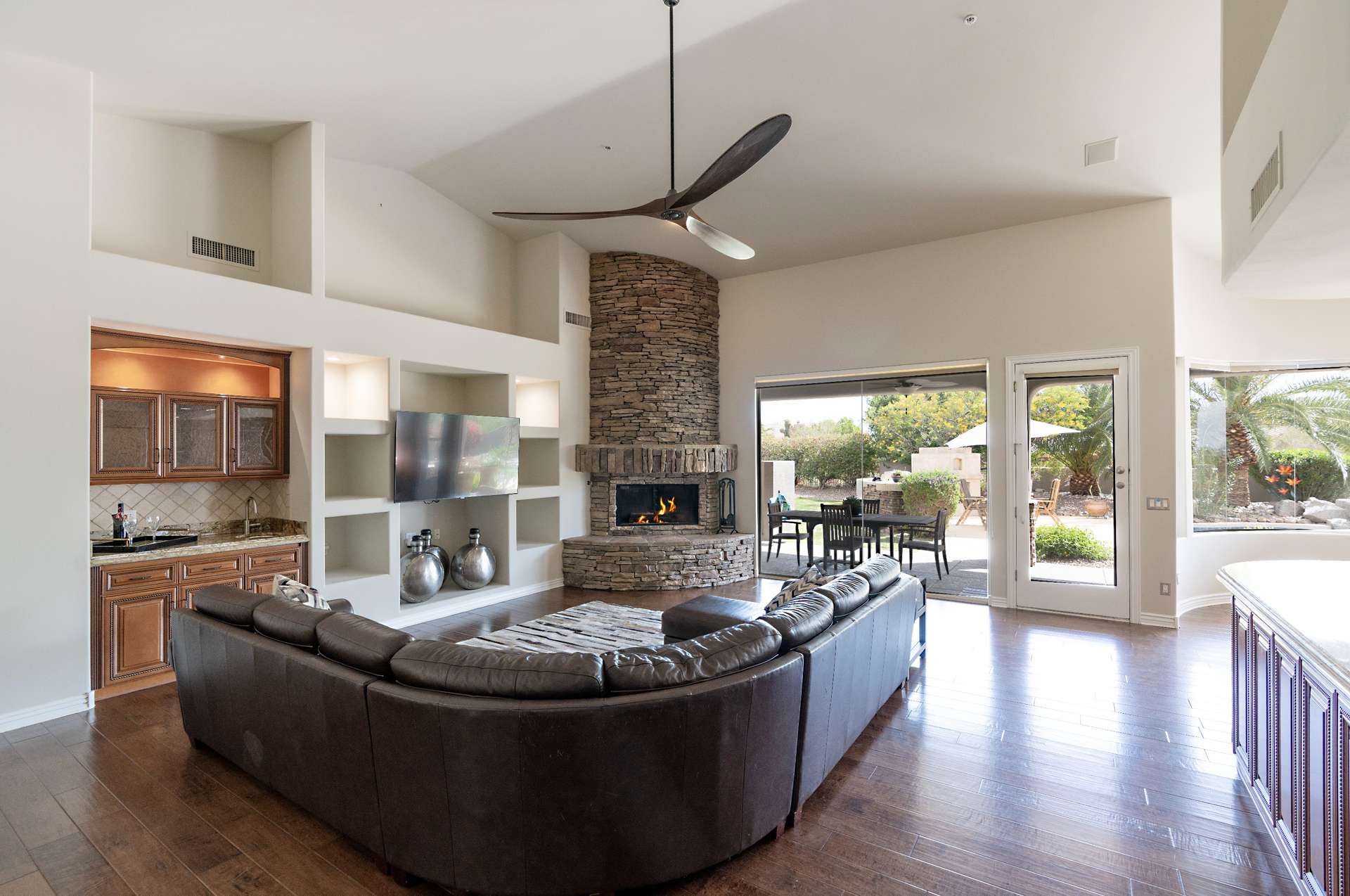 13 of 65. Open the doors to luxury living with this spacious great room. Features include hardwood floors, a stacked-stone fireplace, and access to your private backyard oasis in sunny Scottsdale.
