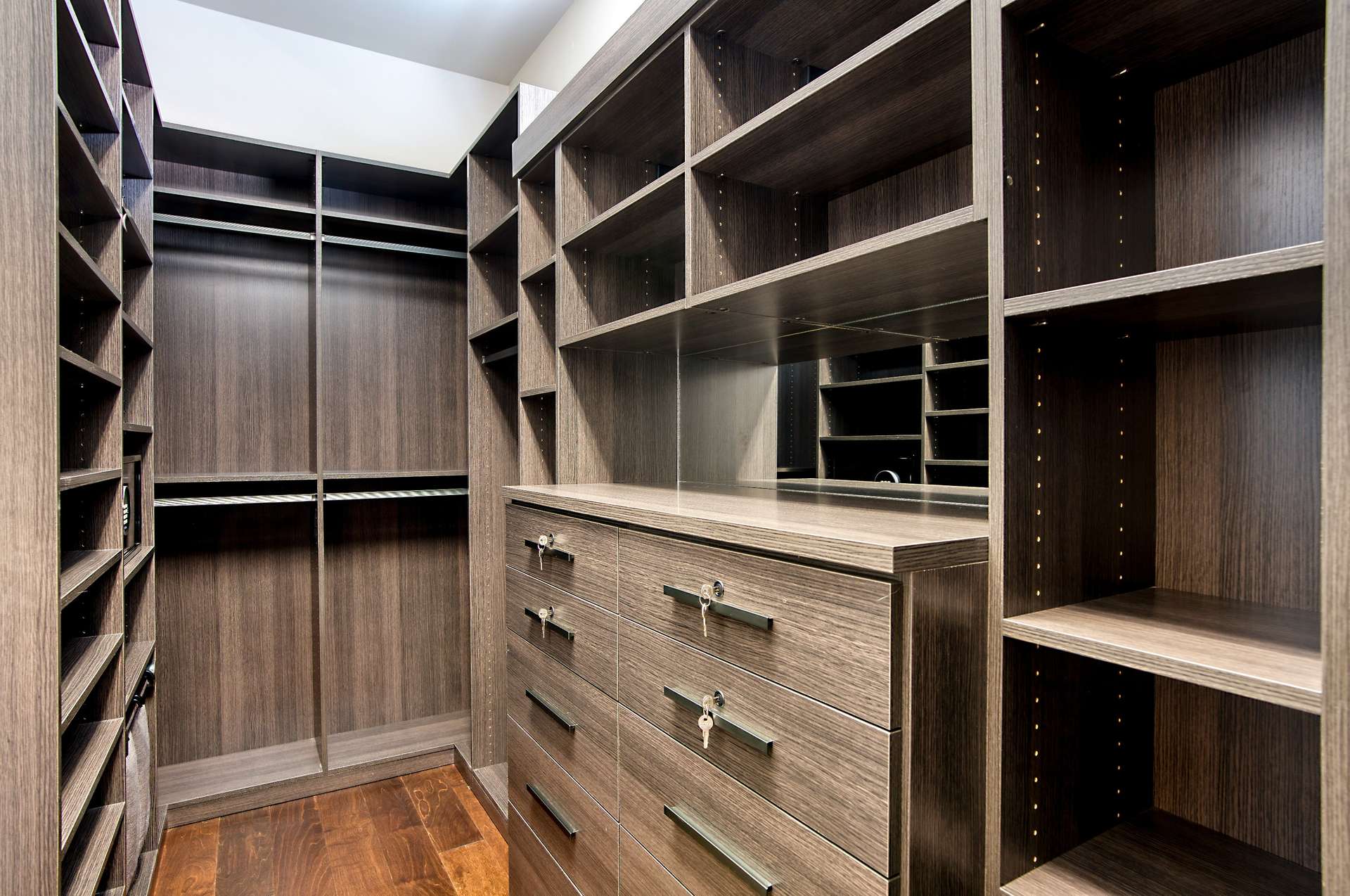 18 of 65. Custom California Closets maximize space with tailored shelving, drawers, and storage in this high-end primary closet. Elegant and efficient design perfect for organized living.