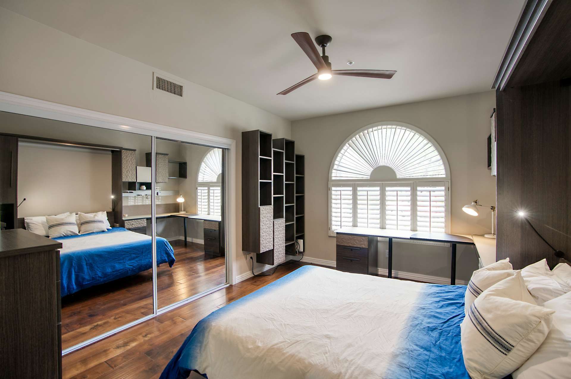 20 of 65. A guest room that works overtime this space includes a sleek Murphy bed, custom shelving, and built-in desk. Perfect for hosting visitors or remote work in a smart, space-saving design.