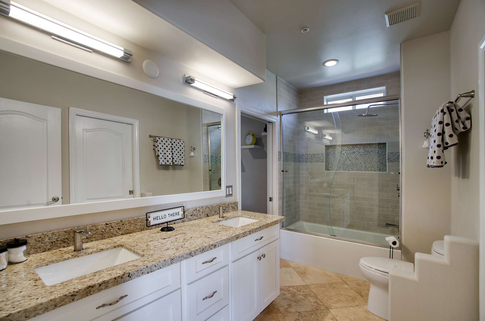 24 of 65. Recently updated, this bathroom features sleek granite countertops, dual sinks, stylish lighting, and a tiled shower/tub combo with a sliding glass door.