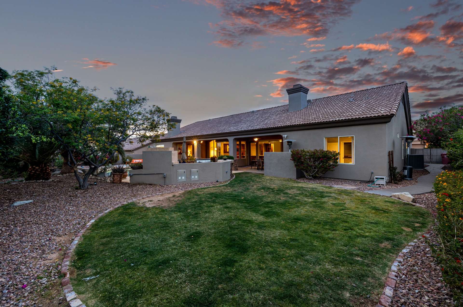 29 of 65. The spacious backyard lawn glows under the evening sky perfect for outdoor activities, family time, or quiet reflection in your own private green space.
